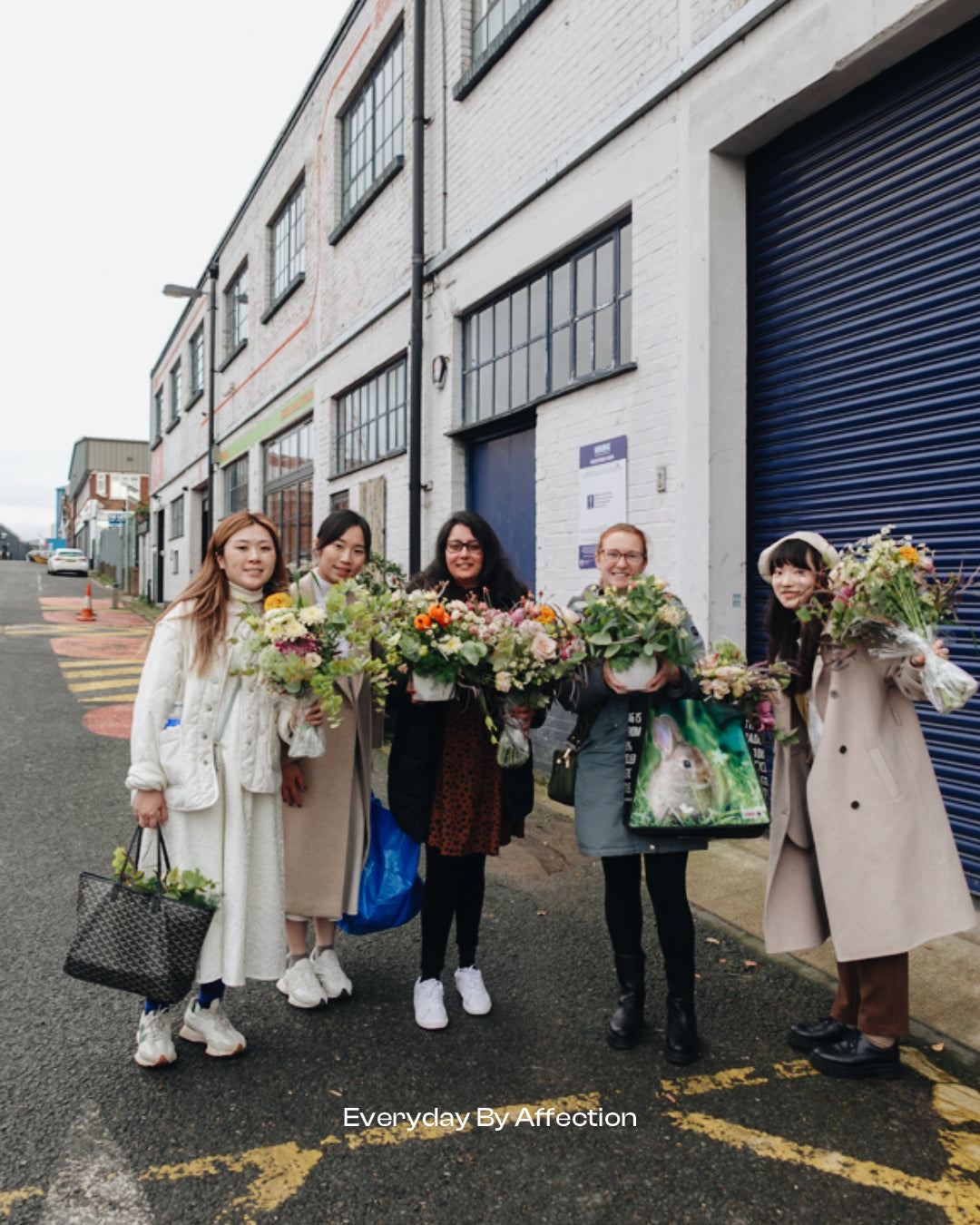 people holding their hand tied bouquets after class