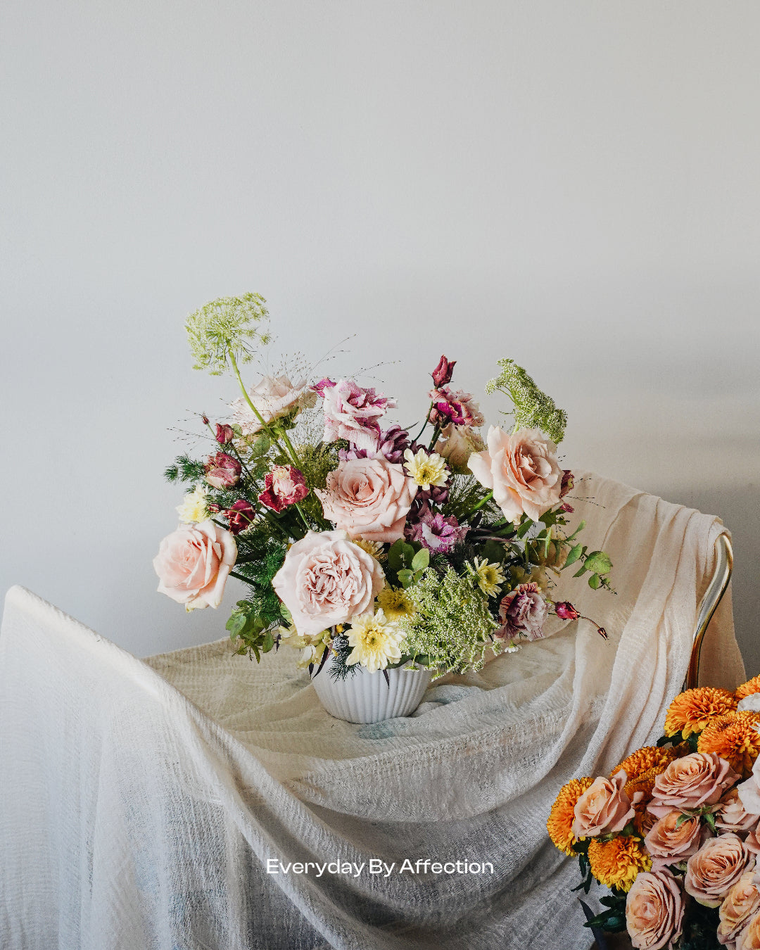 roses and green foliage in low vase