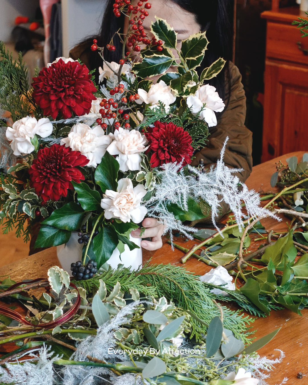 winter flowers and foliage in low vase
