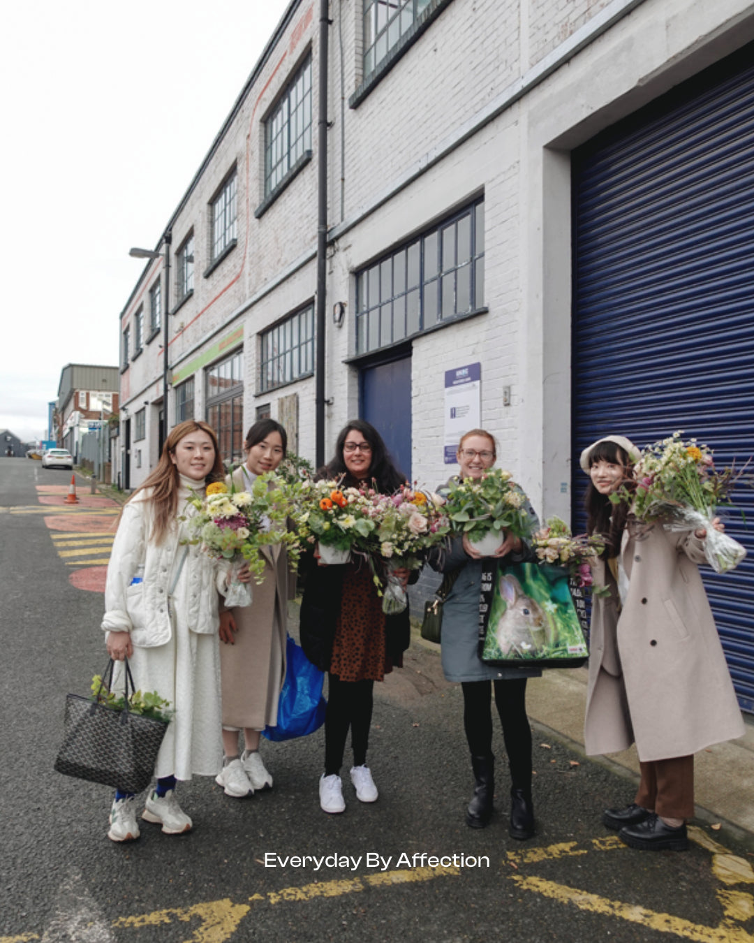 girls holding flowers after an one day floristry class