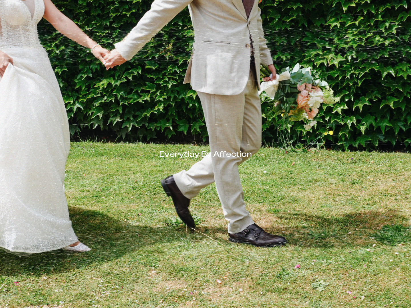 bride and groom holding a bridal bouquet