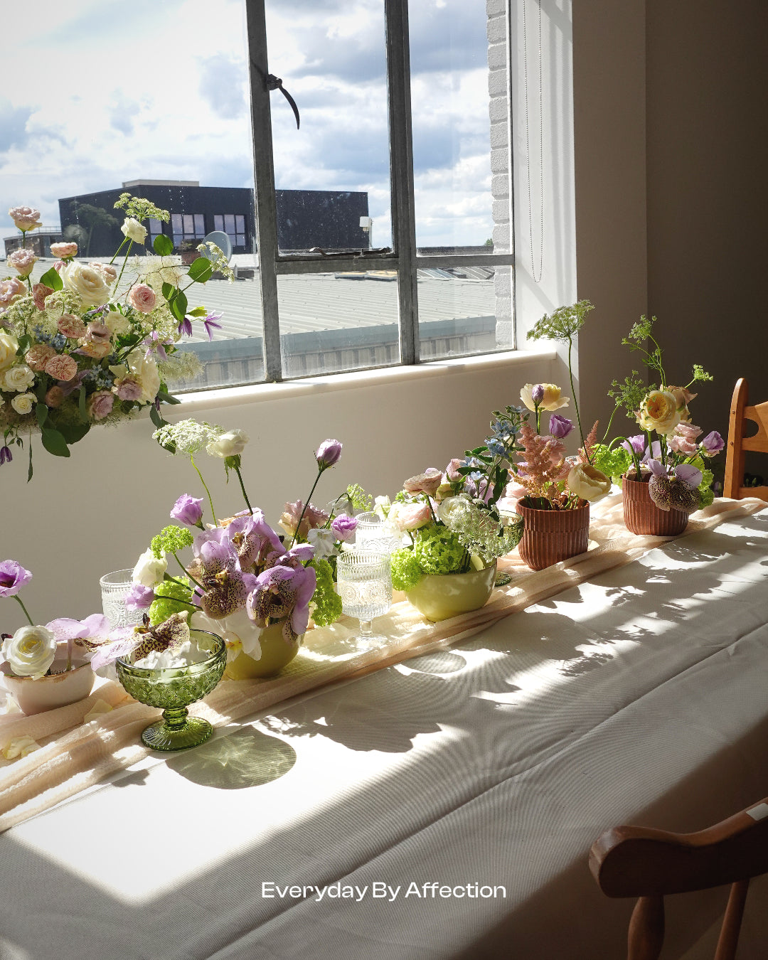 flowers in vases on a long table