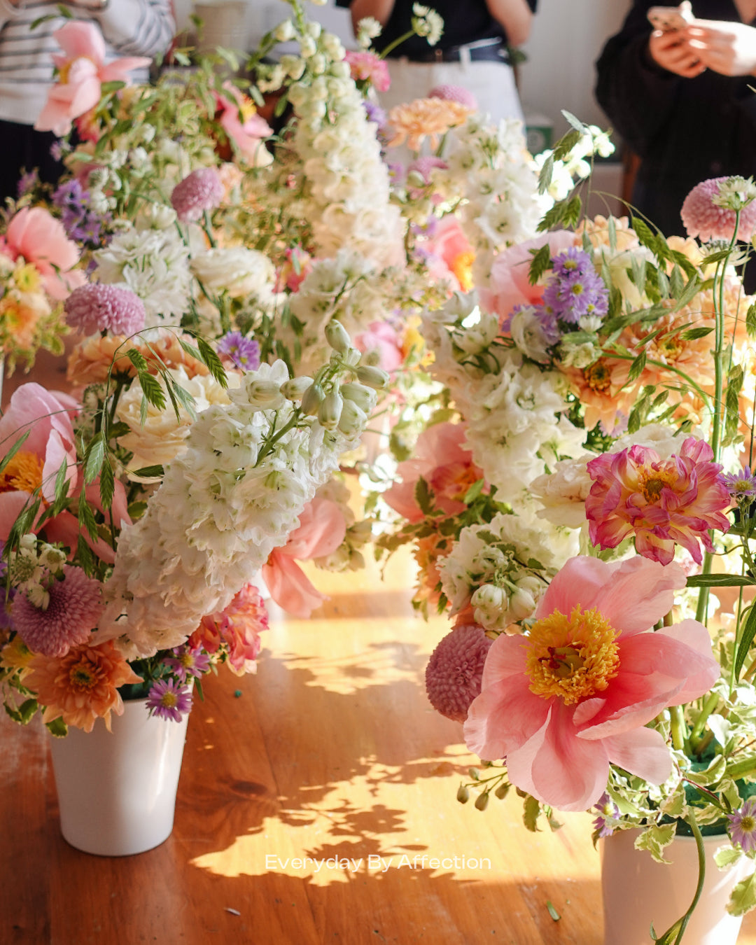 flowers in vases on a wooden table