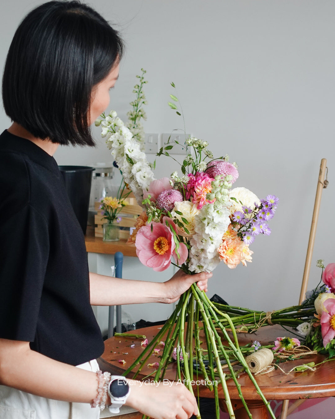 a girl demonstrating hand tied bouquet