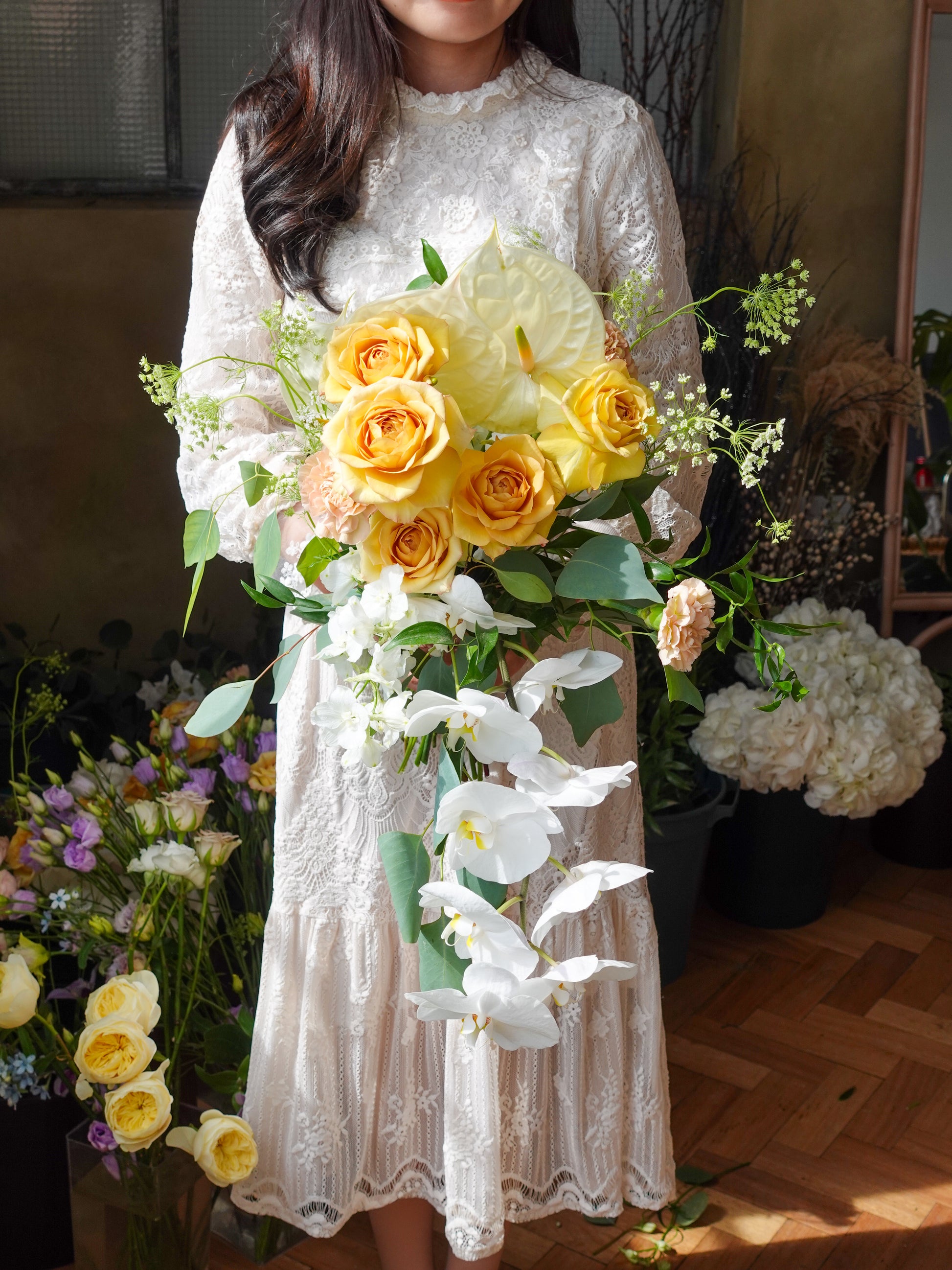 bridal bouquet in roses anthuriums orchids and eucalyptus