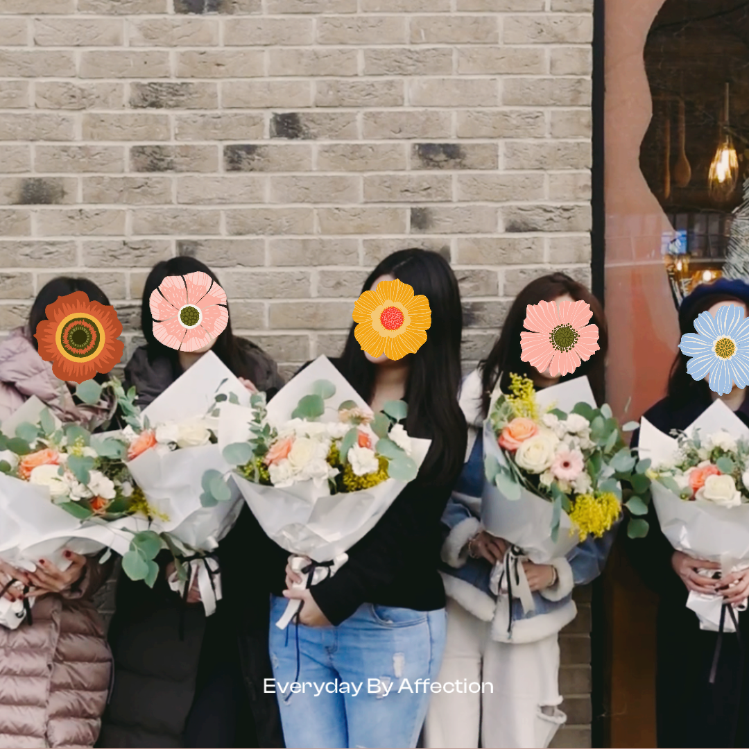 girls holding bridal bouquet wrapped in white papers