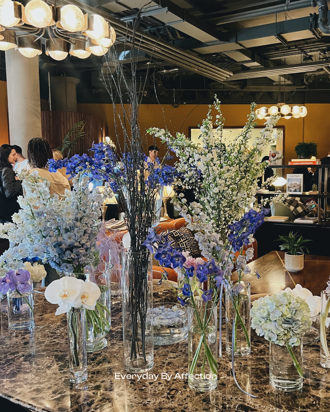 blue flowers on a table in a private club