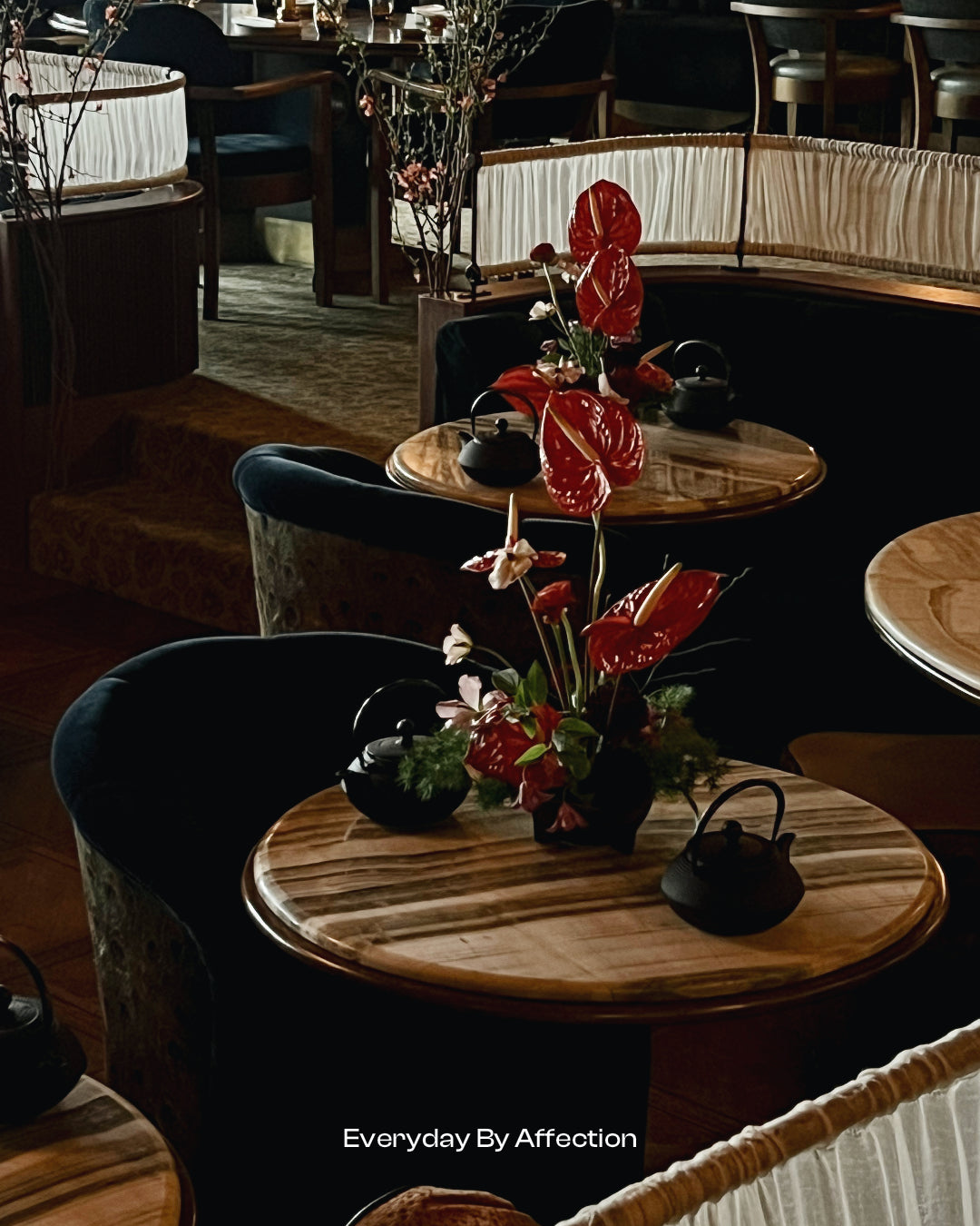 red anthurium flower centrepieces on round tables