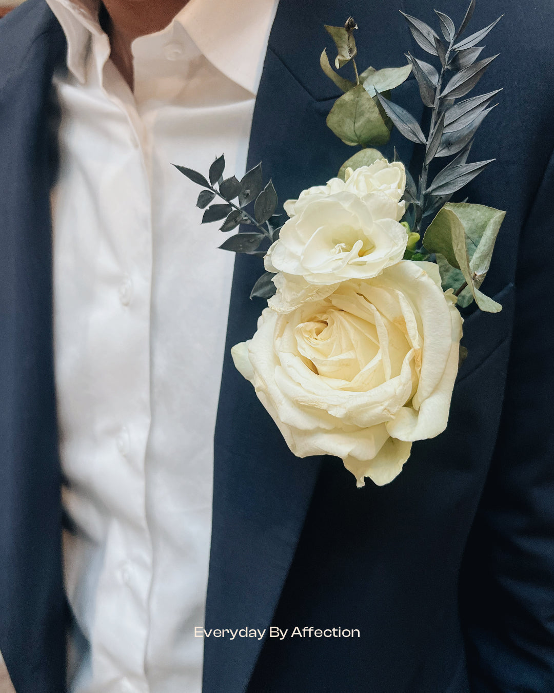 groom buttonhole in white rose with blue suits